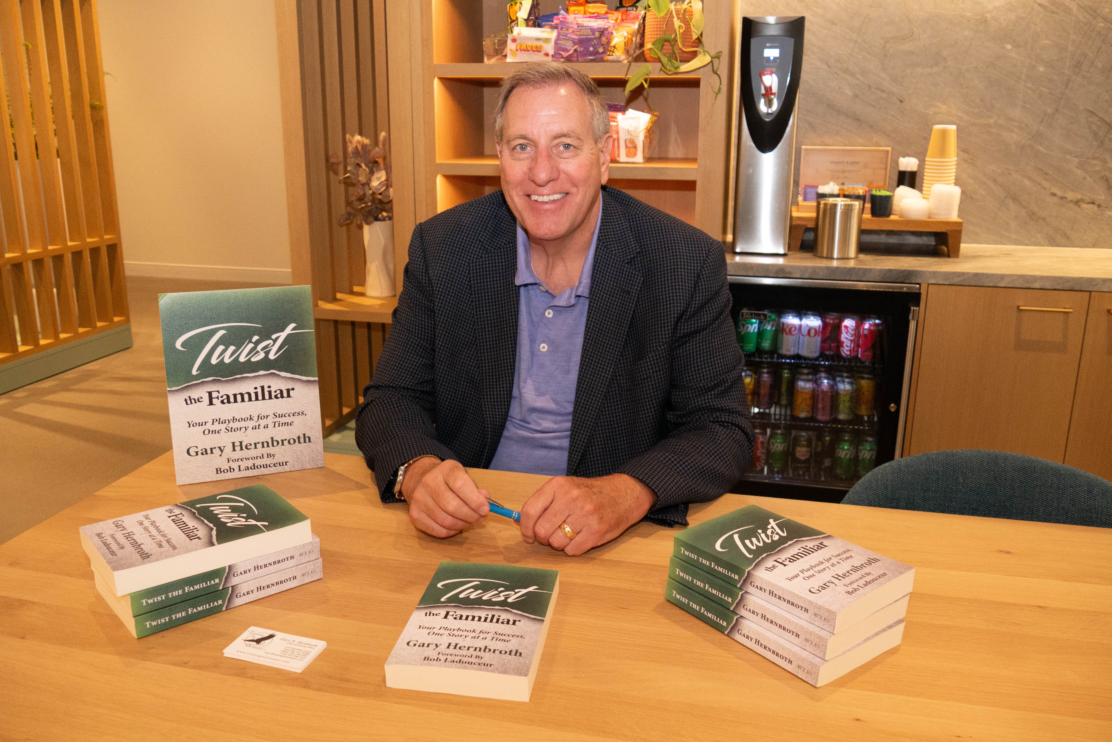 Speaker, Gary Hernsbroth seated for a book signing of his latest business motivation book "Twist the Familiar."