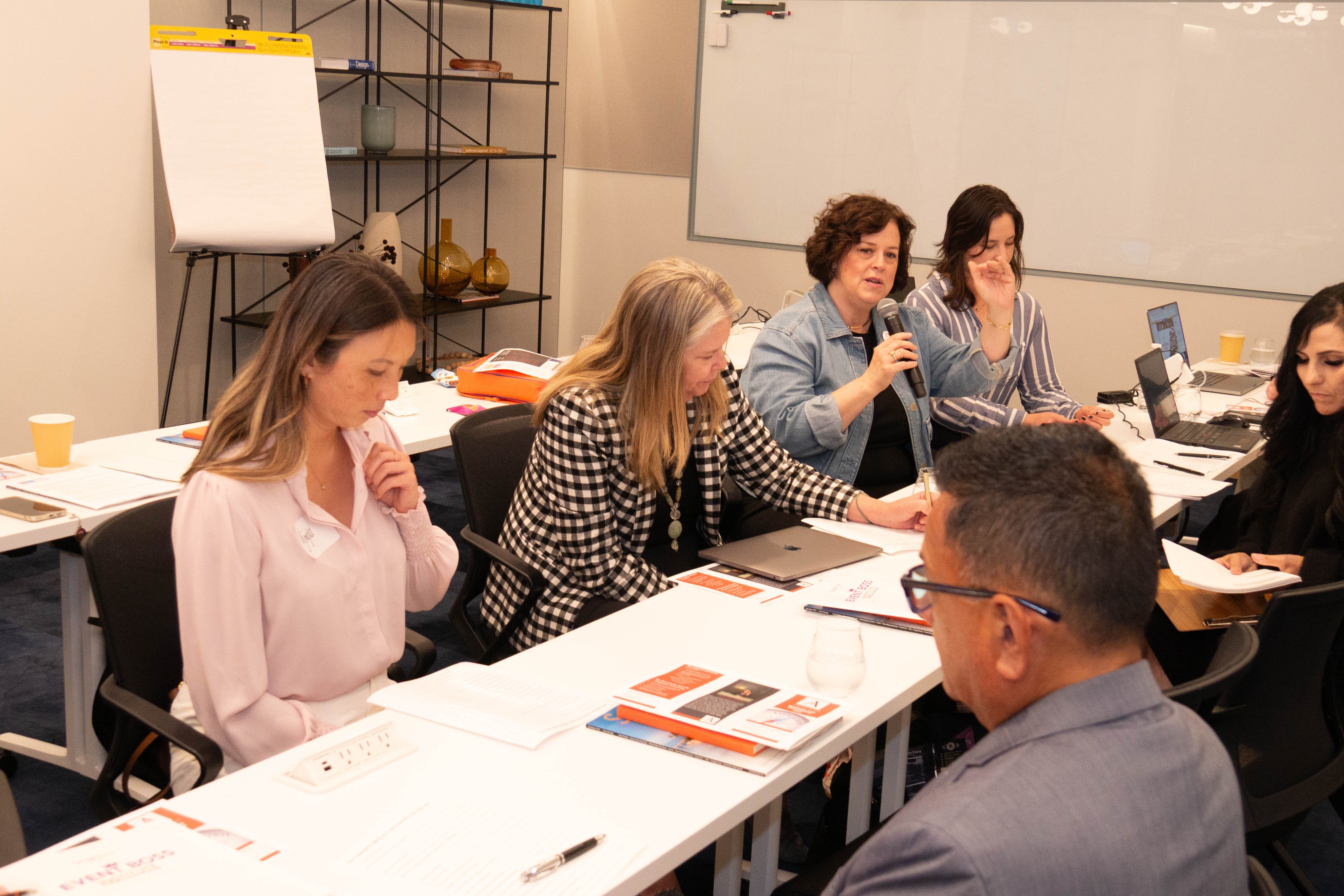 EBI San Francisco attendees asking questions and collectively comopleting their Event Boss workbook.